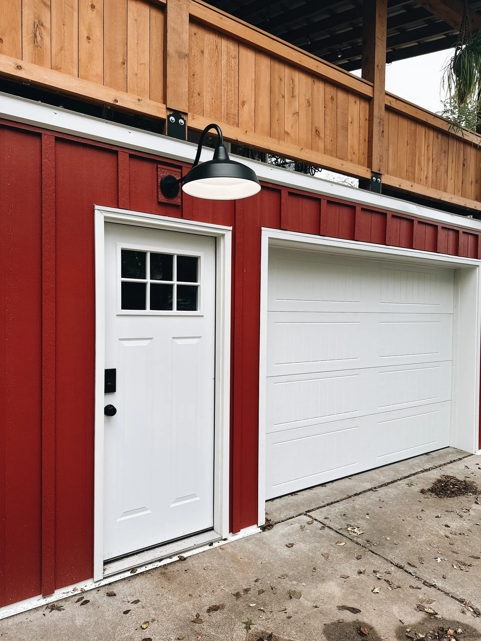 1923 Garage Remodel, Lincoln Nebraska, professional contractors, craftsmanship, red wood siding, matte black light fixture.