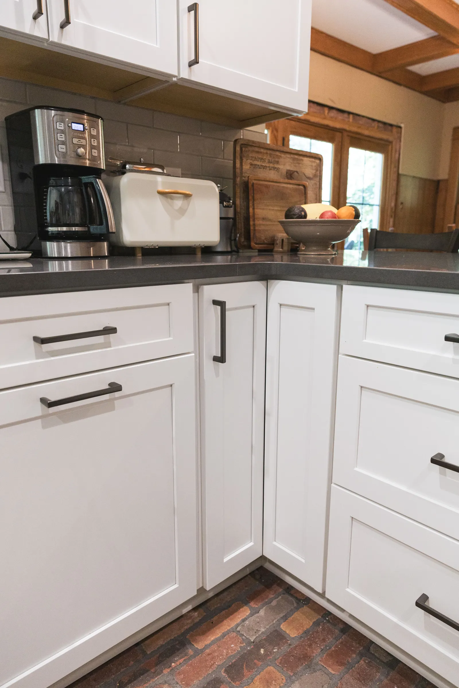 White shaker drawers and cabinets wrapping an inside corner.
