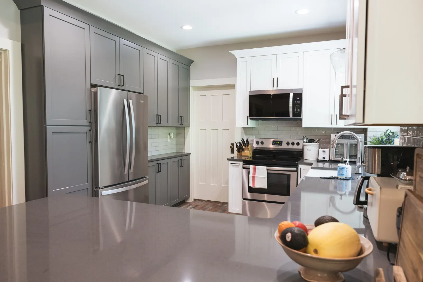 The refrigerator wall and peninsula with the dining room beyond.