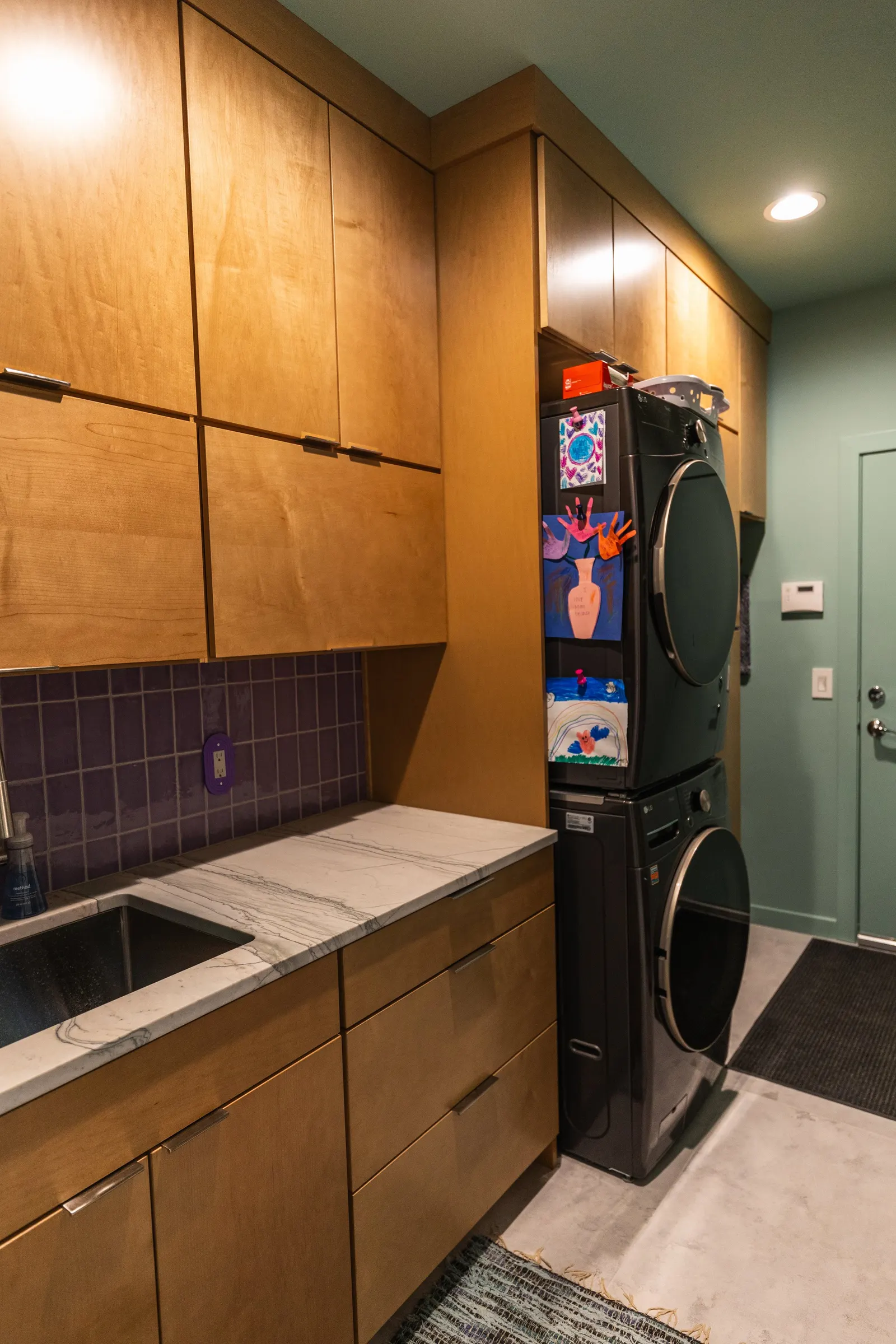 2007 Mudroom Remodel, laundry room, color drenching, custom wood cabinets, quartz countertop, purple subway tile backsplash, laundry room solutions, brushed nickel hardware.