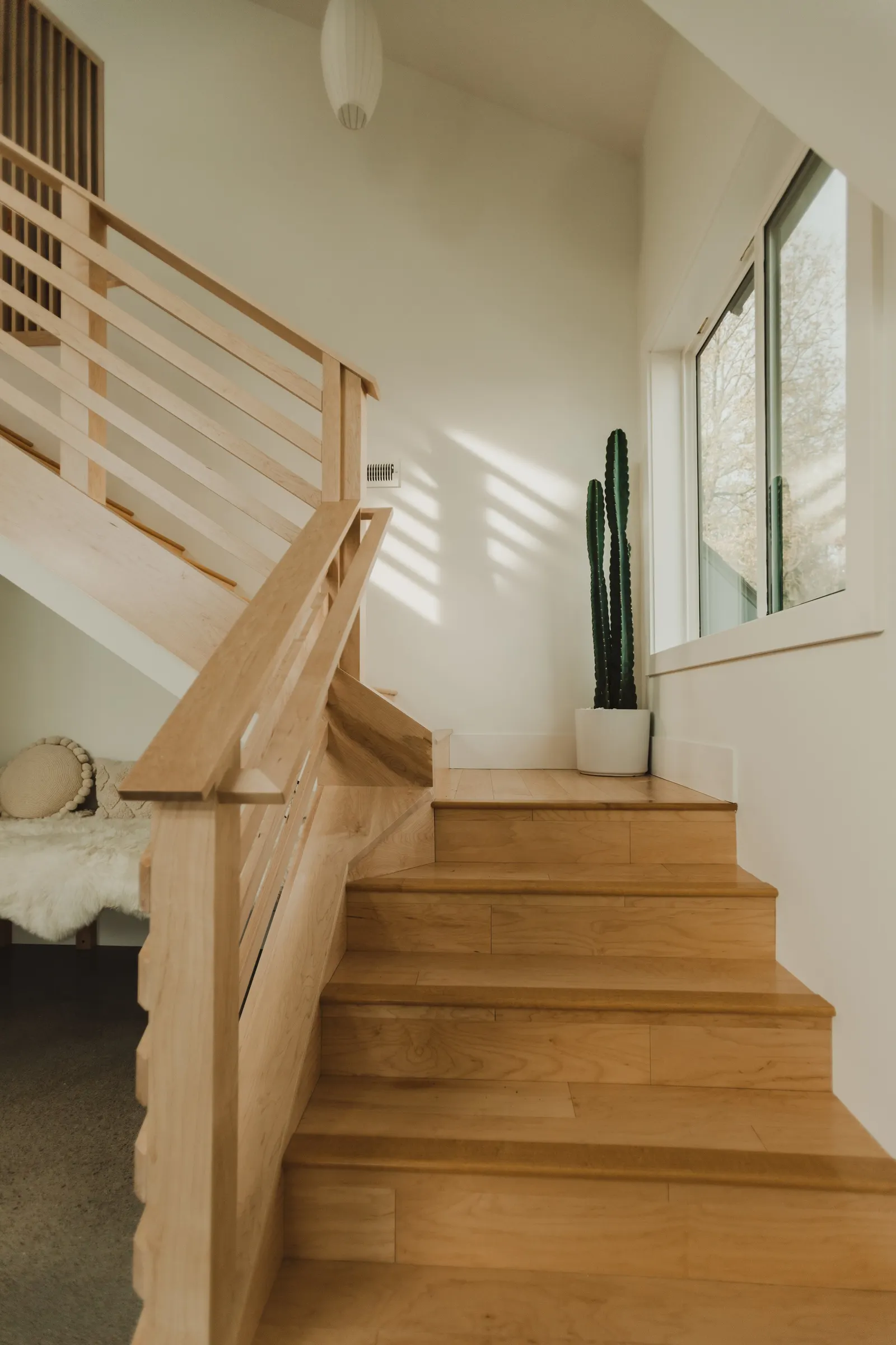 Wooden staircase, open-plan, high vaulted ceiling, large windows, Dahlia House, new build, custom home, Air bnb, mid century design, modern, boho chic, custom staircase, craftsmanship